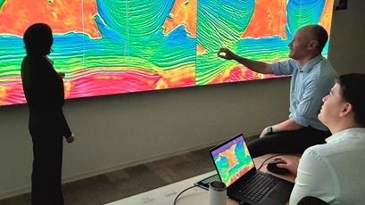 James Davenport, general manager of Geophysics and Petrophysics at Chevron (center), discusses full waveform inversion (FWI) seismic imaging of the Anchor deep water development in the Gulf of America with Chevron exploration geophysicists Jennifer Zhang (left) and Casey Ruplinger.
